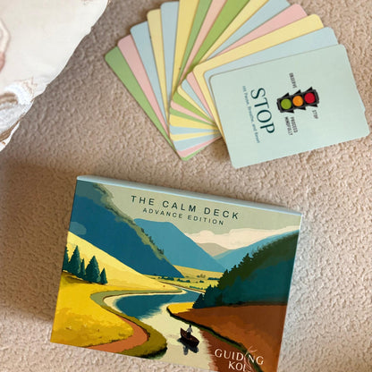 The Calm Deck Advance Edition by Guiding Koi displayed with colorful mindfulness cards spread out, including a “STOP” card - a psychologist-designed tool to manage anxiety and emotional stress.