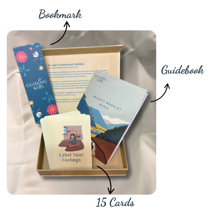 Open Guiding Koi Calm Deck box displaying 15 mindfulness cards, a blue floral bookmark, and an Anxiety Booklet guidebook - tools designed by psychologists for stress and anxiety relief.