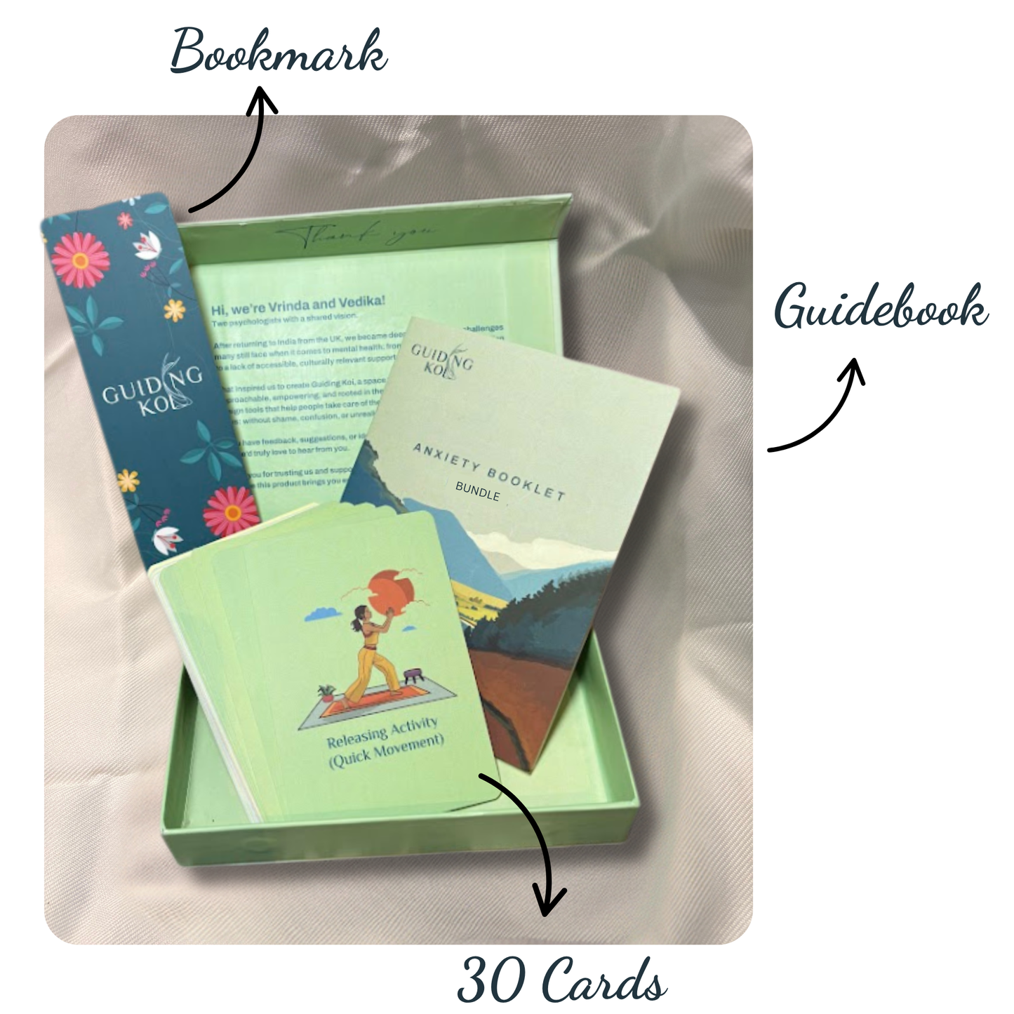 Open Guiding Koi Calm Deck Bundle Edition box featuring 30 illustrated mindfulness cards, a floral bookmark, and an Anxiety Booklet guidebook — designed by psychologists for stress and anxiety relief.