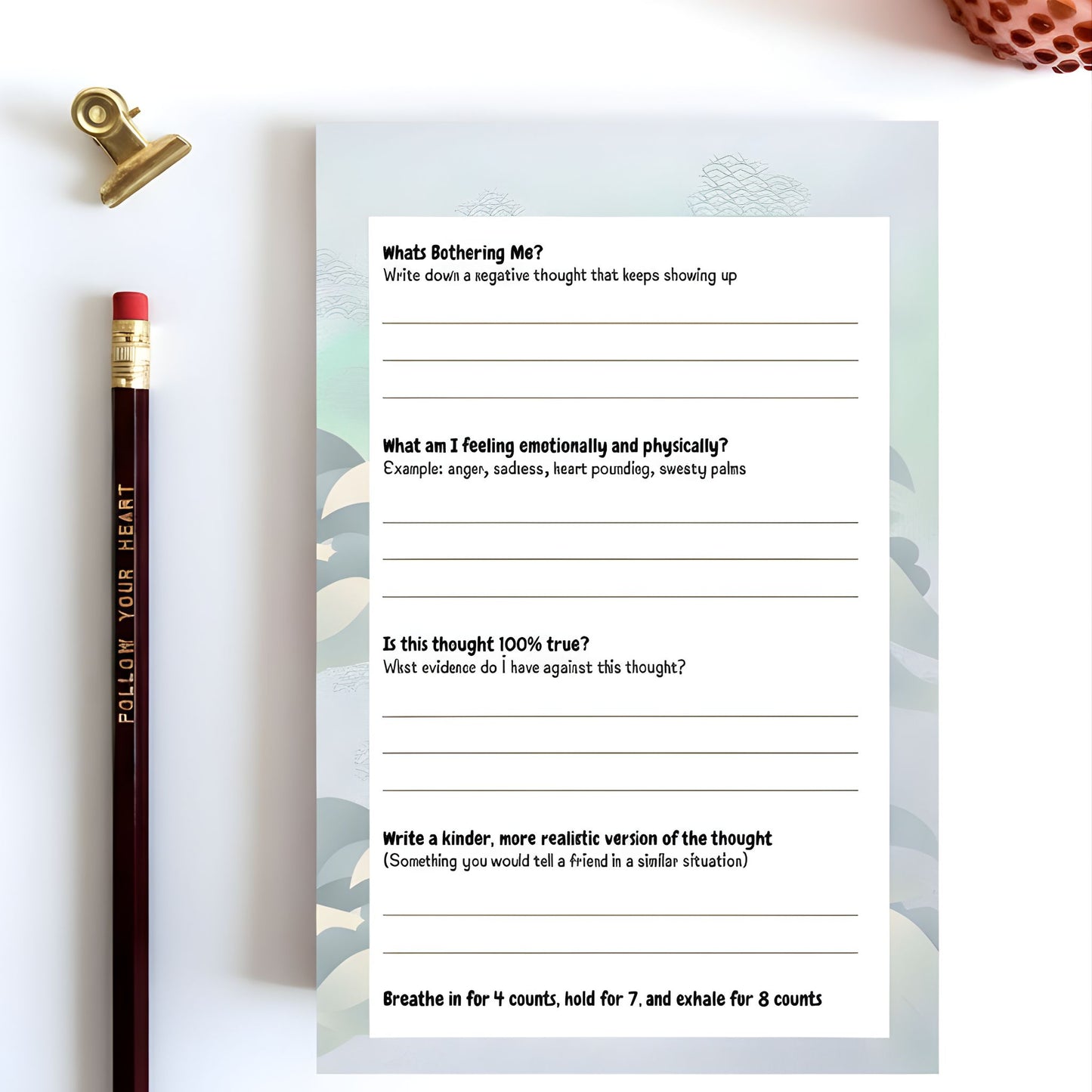 Reframe Notepad interior page by Guiding Koi showing a CBT-inspired thought reframing worksheet with guided prompts for identifying negative thoughts, emotional responses, evidence, and kinder reframe statements.